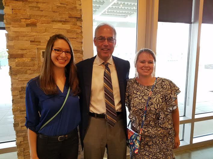students smiling with their boss