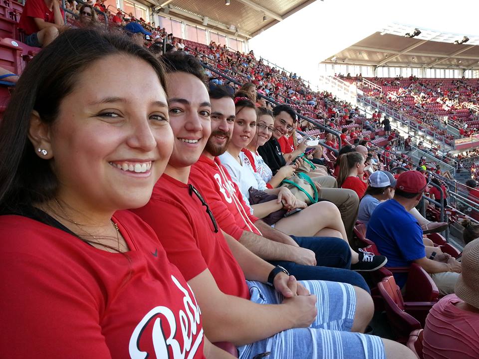 students enjoying a reds game