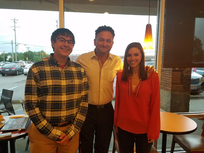 students posing with their boss